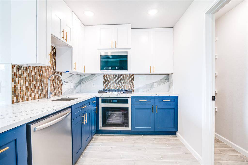 Gorgeous Cambria quartz countertops throughout the kitchen and stainless steel appliances
