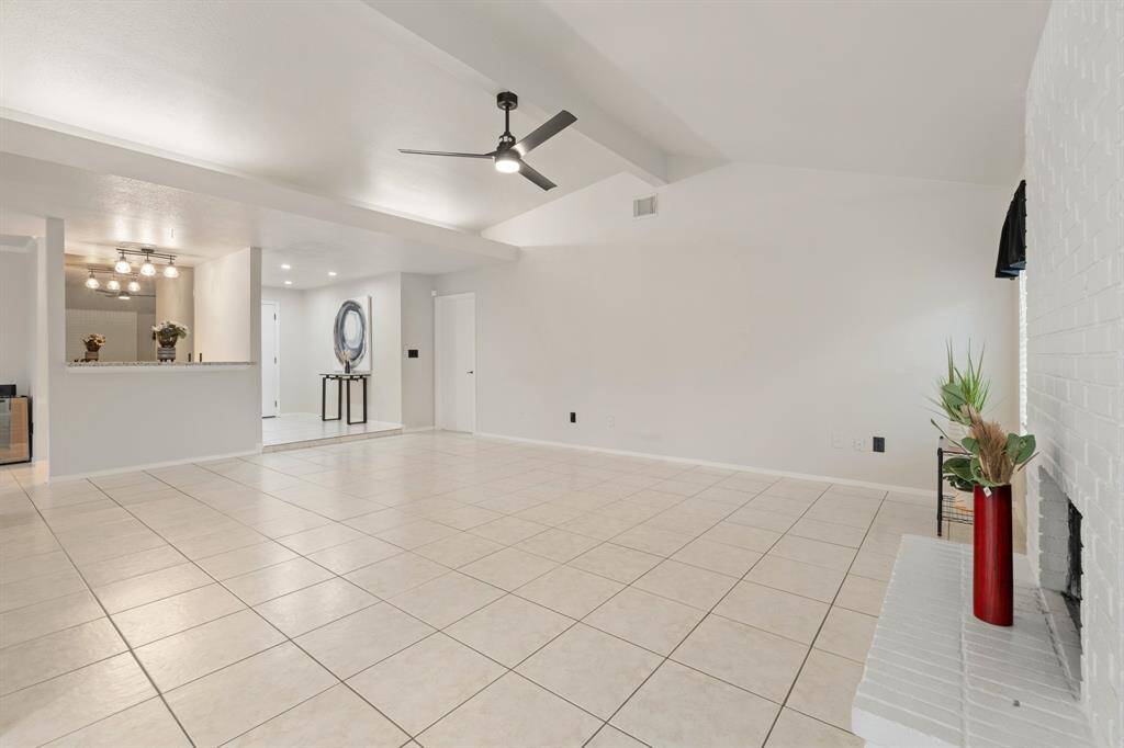 This living area is a large space with a comfortable and inviting feel with easy care tile flooring.