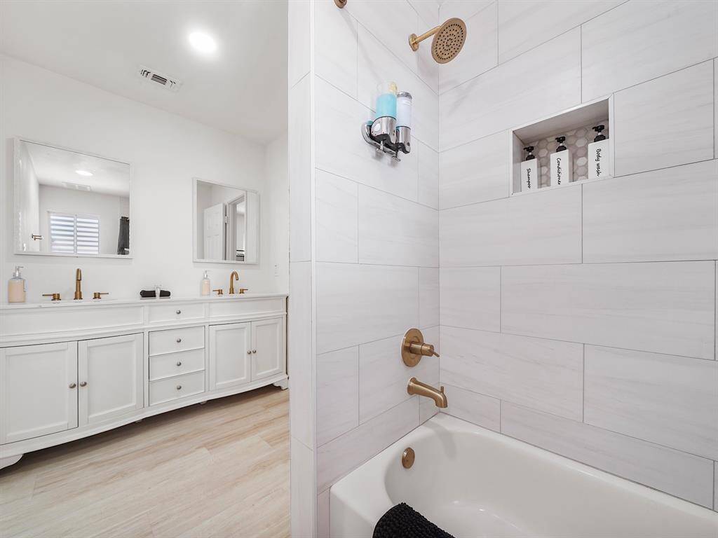 beautifully designed Jack and Jill bathroom, perfect for families or shared living spaces. This stylish bathroom boasts dual sinks, offering convenience and ample space for both functionality and comfort.