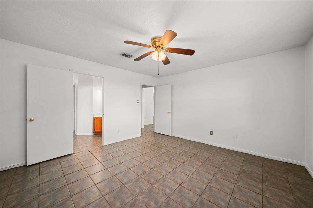 The 14.4 x 13.7' primary bedroom offers plenty of space to accommodate large furniture.  All bedrooms as well as the living room have ceiling fans in place.