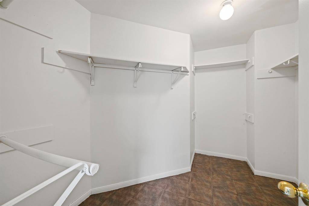 The large walk-in closet in the primary offers plenty of hanging as well as shelf space (not visible, to the right of the door).