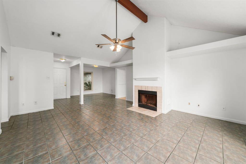 The large and open living area offers vaulted ceilings, an architectural beam and art niches, as well as an adjacent space next to the front door that works great as a home office or dining area. Tile flooring throughout!