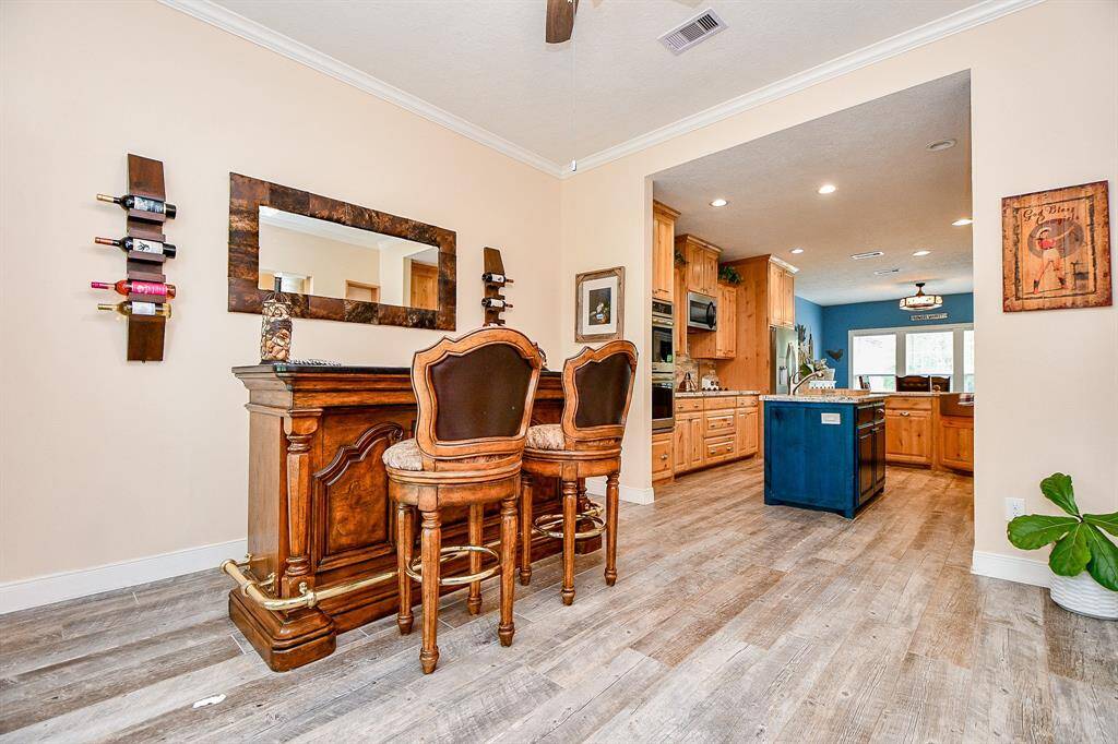 The formal ding room opens into a spacious kitchen with warm cabinetry, a central island, and ample natural light, creating a perfect blend of style and functionality for entertaining and everyday living.