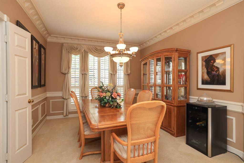 The Dining Room has plush carpet and crown dentil moldings.