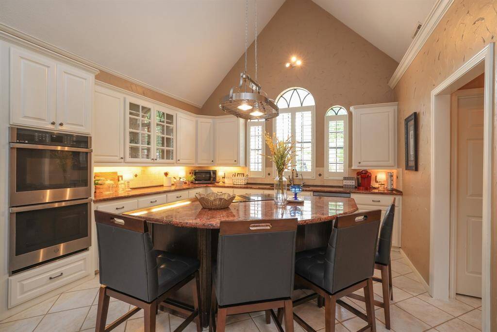 Awesome kitchen with large granite island with breakfast bar seating