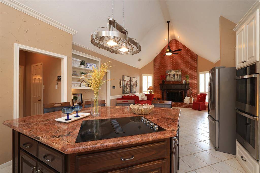 A close up of the island looking into the Family Room.  The walk in pantry and laundry room are just through the door to the left.  A built in desk and shelves - great for family planning!