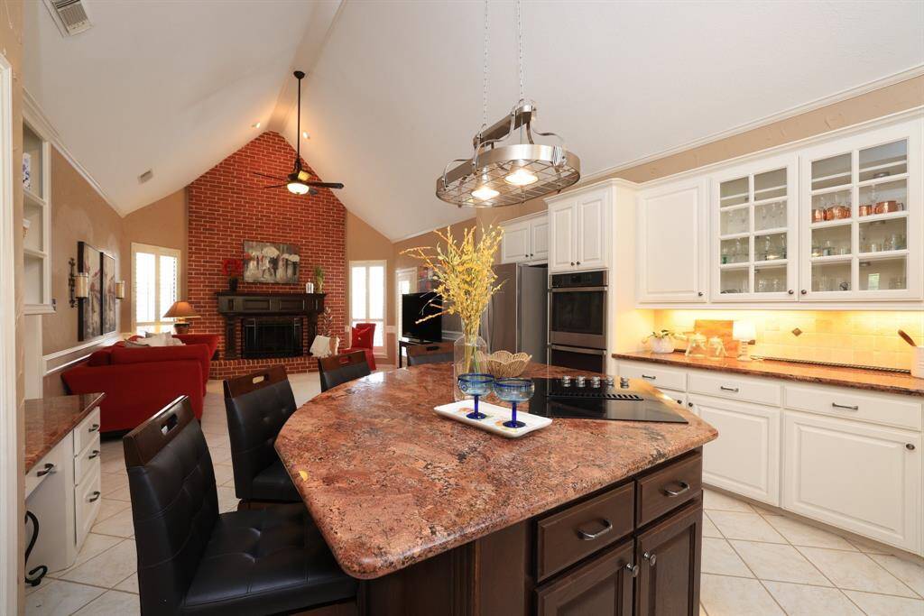 Stainless appliances include a double oven, dishwasher and electric stove.  Undercabinet lighting and glass fronted cabinets add to this special kitchen!