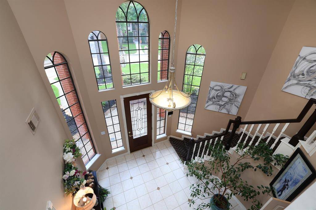 A view from the upstairs to the entry.  Cathedral windows add so much natural lighting!