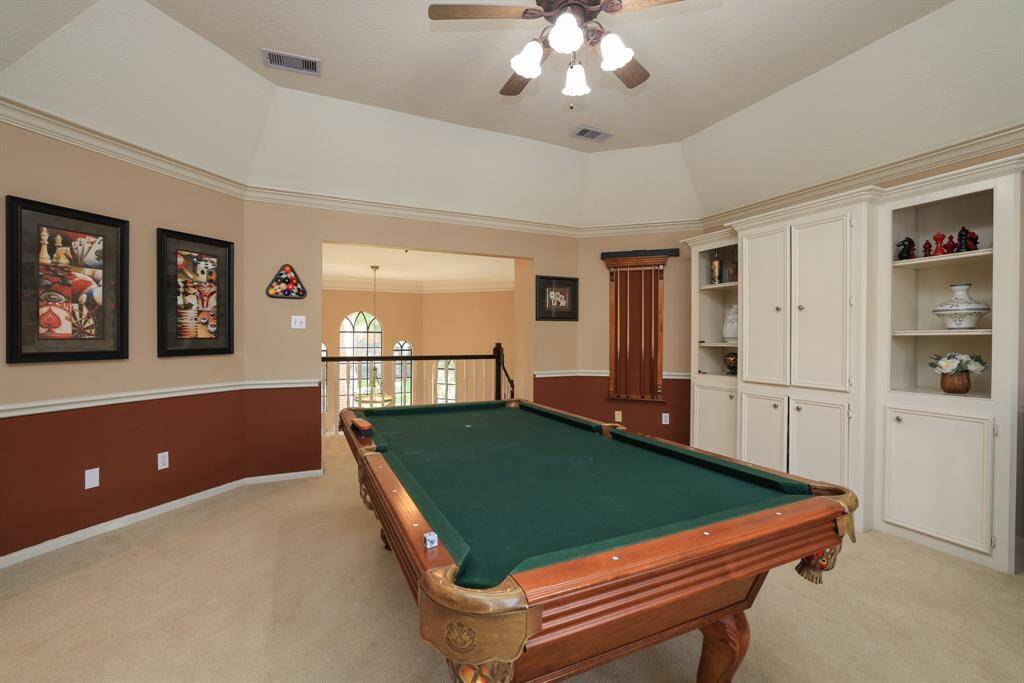 The game room is located at the top of the stairs with bedrooms on each side