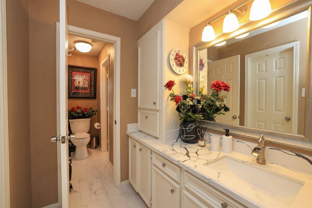 Second floor bathroom is beautifully remodeled with quarts counters and new lighting..