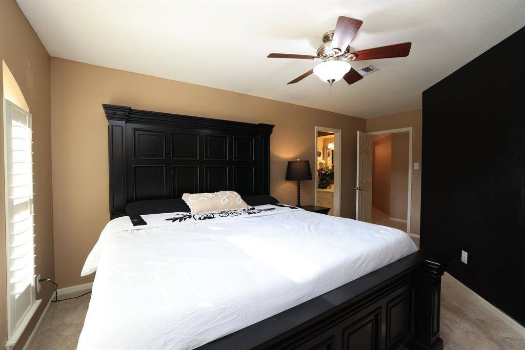 This view of the secondary bedroom shows the access to the remodeled bathroom.