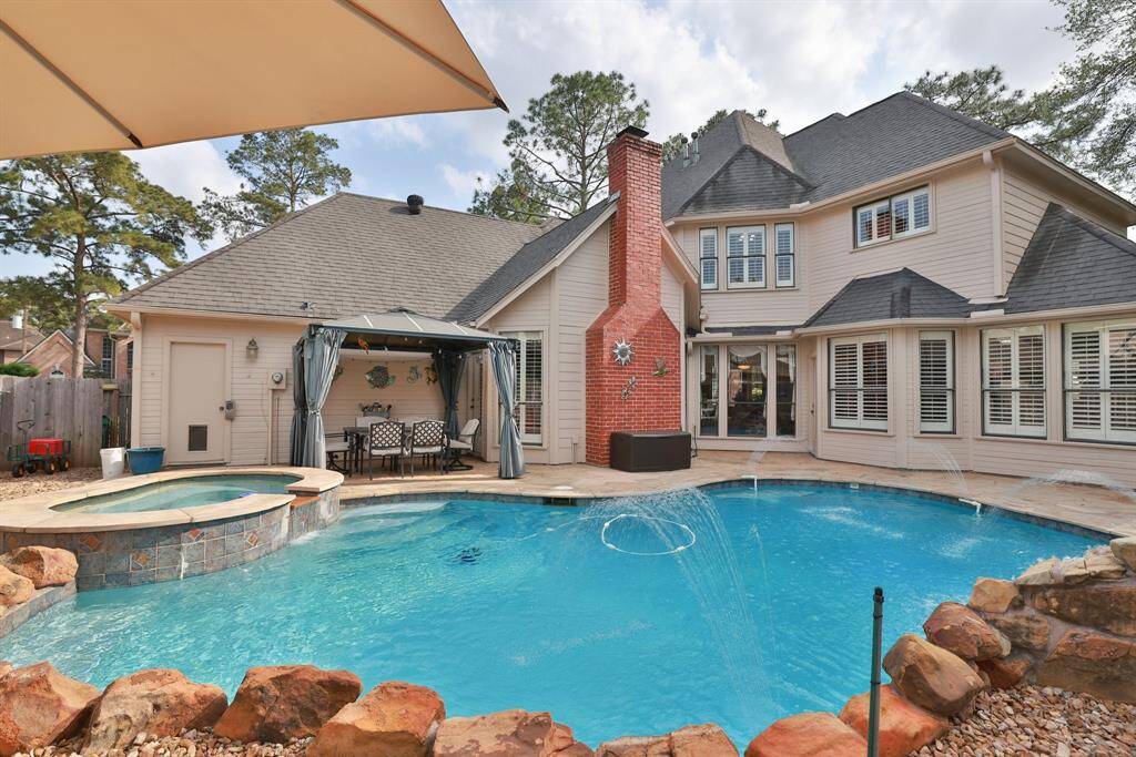 This beautiful traditional home with backyard pool, spa and waterfall is a calming retreat.