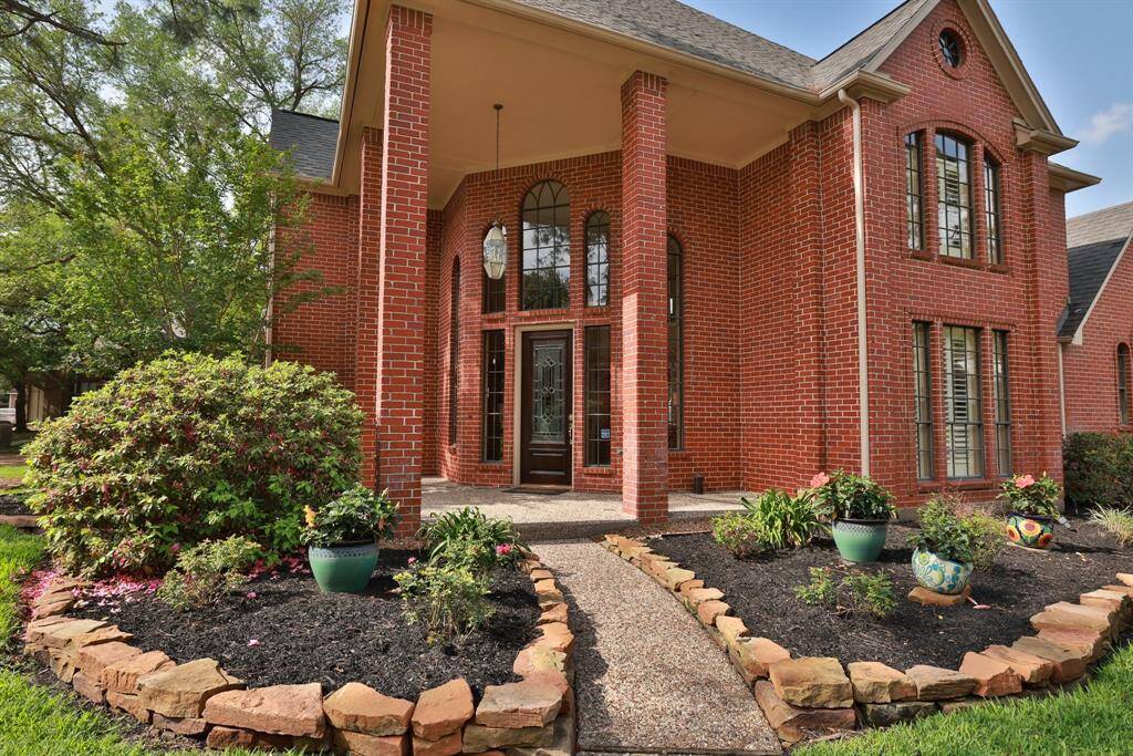 Stunning entry with lead glass front door and windows surrounding the door.