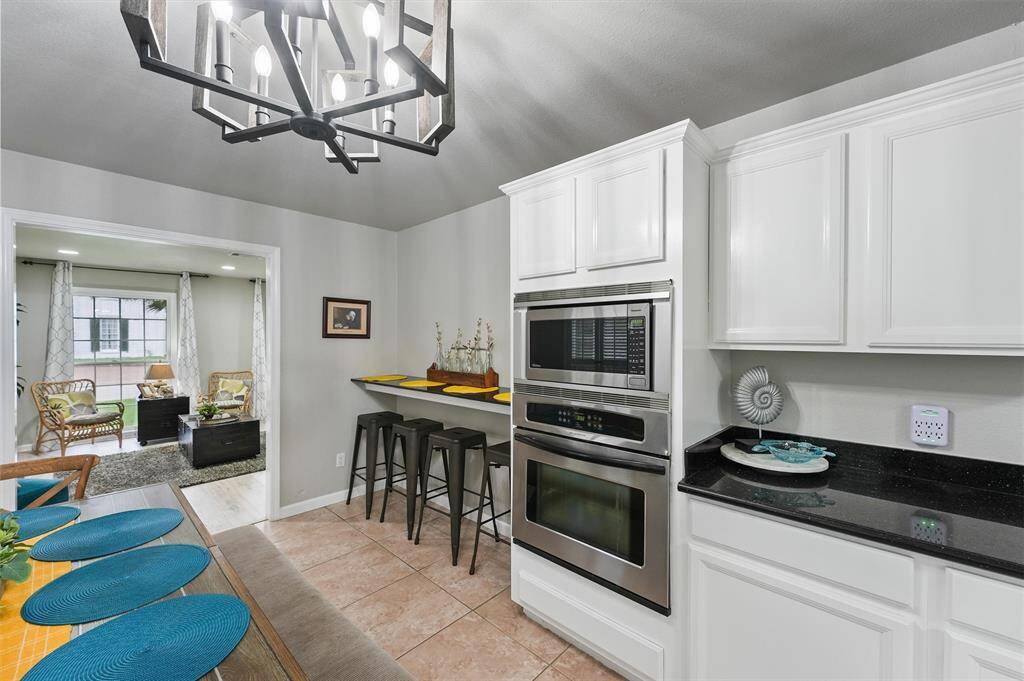 Built-in stainless steel appliances and a convenient eat-in bar make this kitchen both functional and stylish.