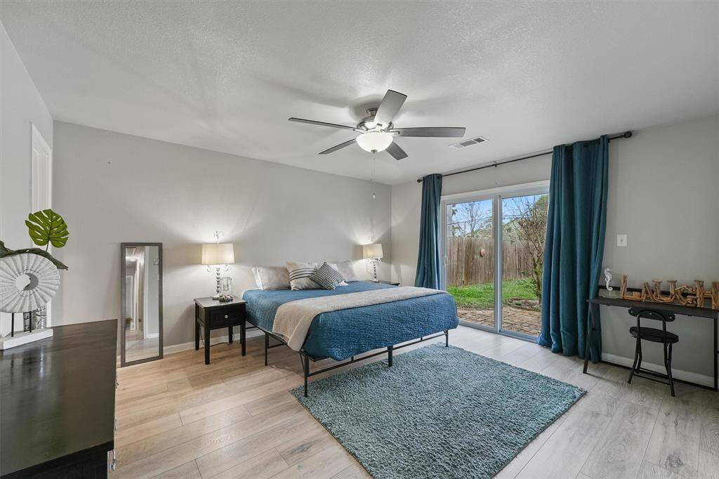The primary suite is a relaxing haven with private sliding door access to the backyard and tons of natural light.