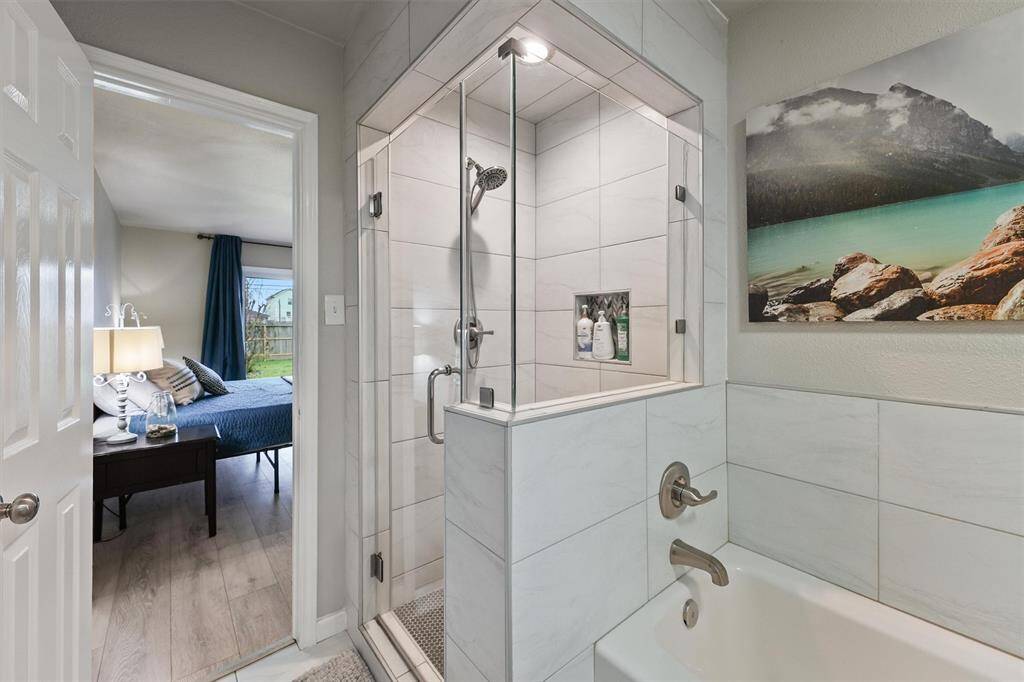 A sleek walk-in shower and separate tub make this bathroom both stylish and functional.
