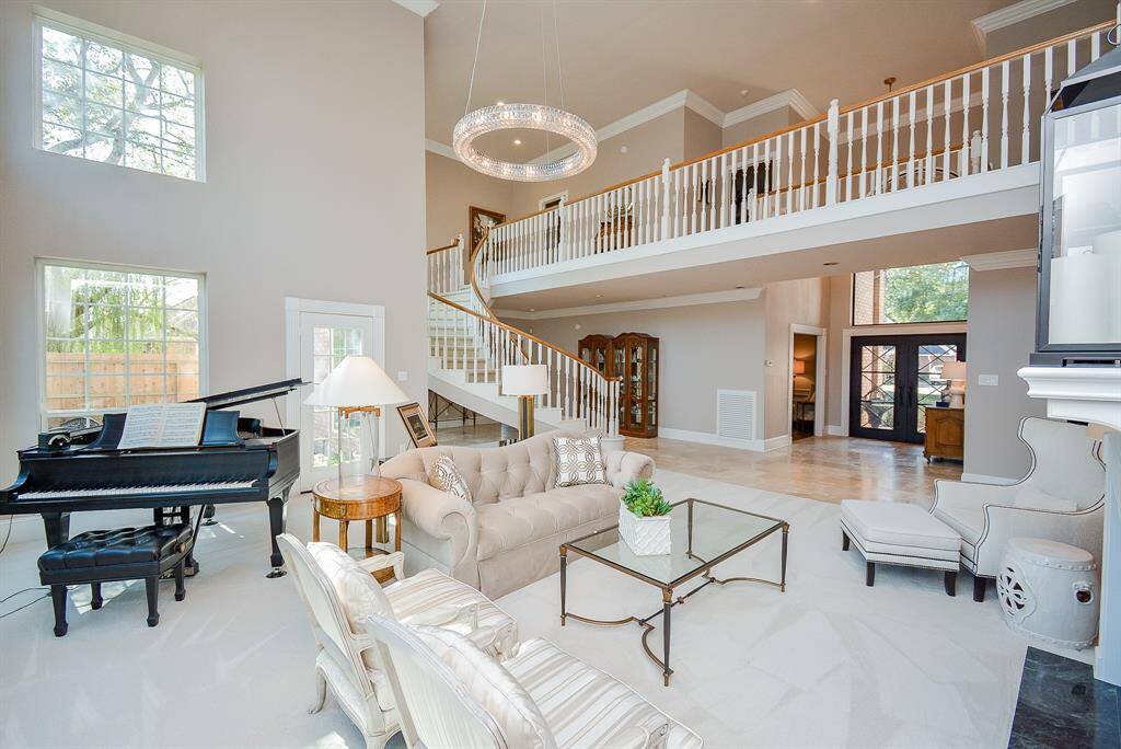 This photo showcases a Double Sided Marble Fireplace that's open to the adjacent Formal Dining Room creating an inviting and luxurious atmosphere.