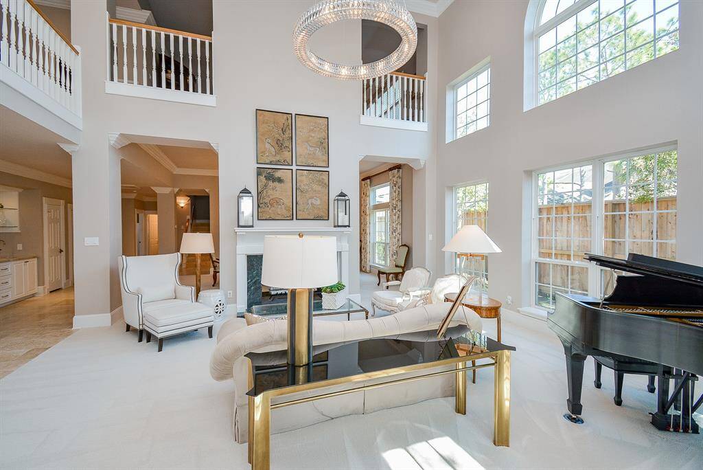 Sweeping staircase with elegant white railings and wooden accents.