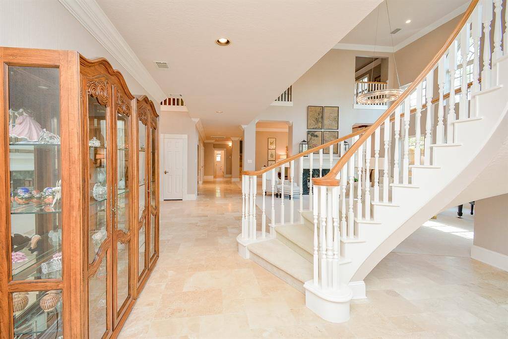 The Generous Dining Room with a Big Window, Wide Crown molding, Classic Chandelier and Fireplace with Art Lighting can easily accommodate a very large table making your Dinner Parties Spectacular!