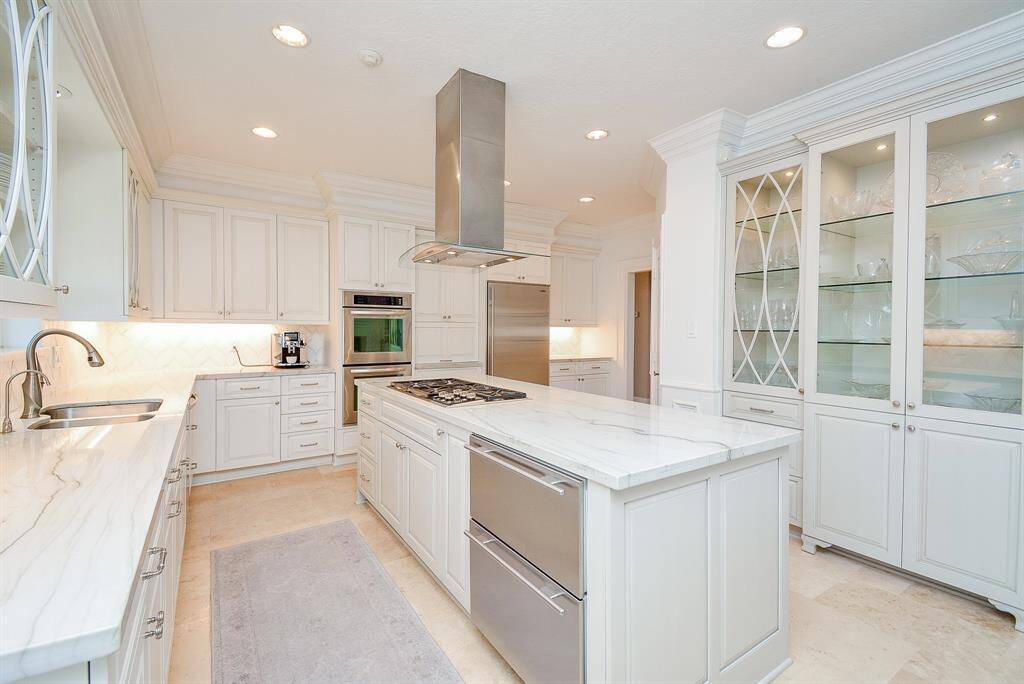 This photo shows the 5-Burner Gas Cooktop and Walk-In Pantry.