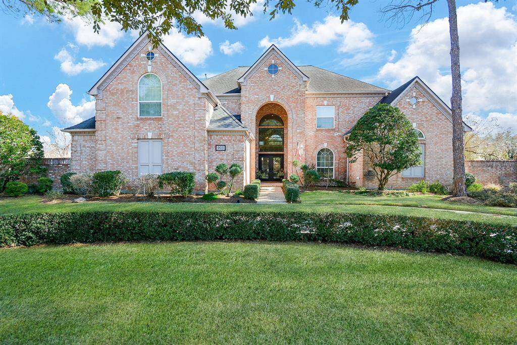 Amazing Curb Appeal with Large Arched Windows, Well Maintained Lush landscaping with Mature Trees and a Spacious Front Yard!