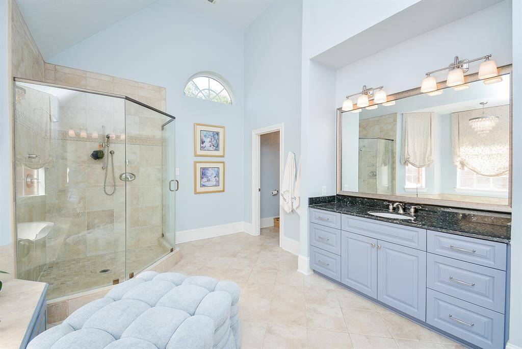 This luxurious soaking tub with elegant tile surround is the perfect place to relax with a glass of wine and forget your worries of the day.