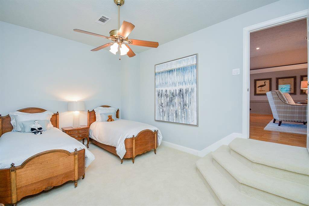 The sizable Game Room with Book Shelfs, Crown Molding and lots of Recessed Lighting is only limited by your imagination.