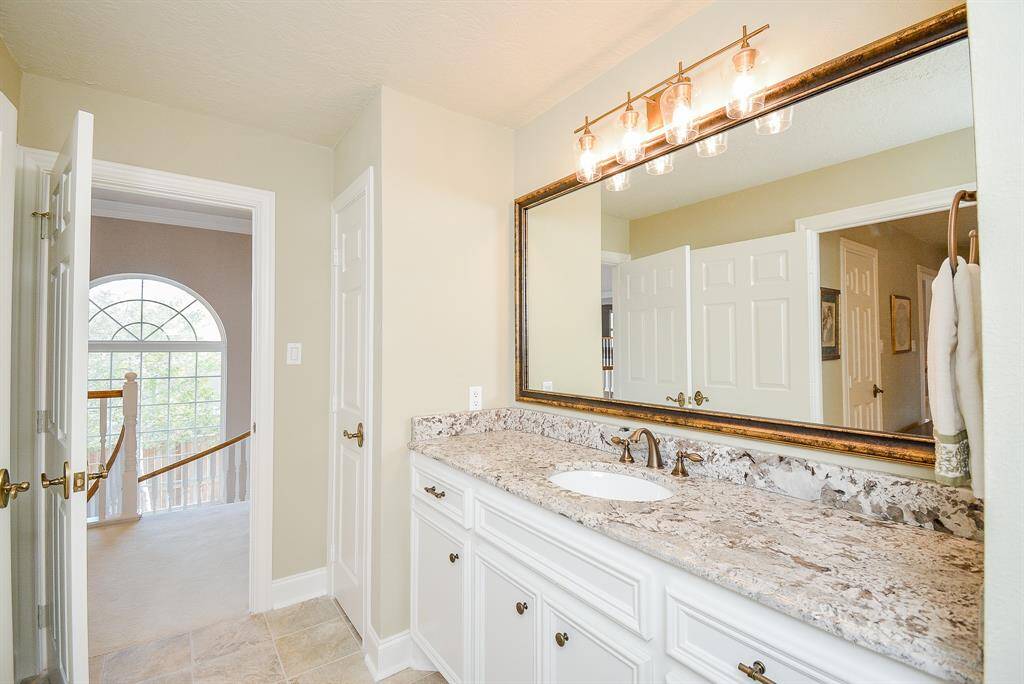 This spacious bedroom features a vaulted ceiling and cozy neutral tones.
