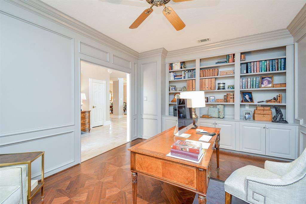 This Spacious Grand Living Room brings the WOW Factor with High Ceilings, Crown Molding, Stunning Spiral Staircase, and a Modern Chandelier and Abundant Natural Light from Multiple Large Windows