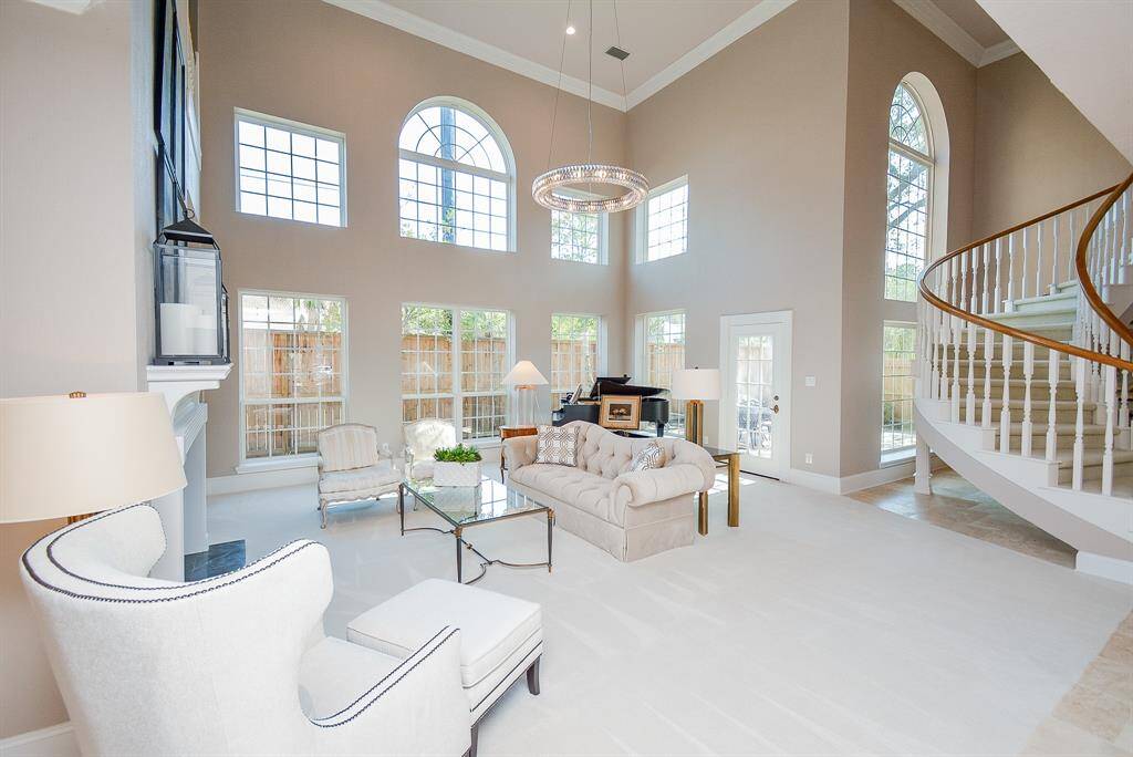 This Large Living with Soaring Ceilings and a Catwalk enhances the airy feel.
