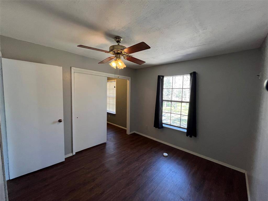 Spacious bedroom with ceiling fan already installed.