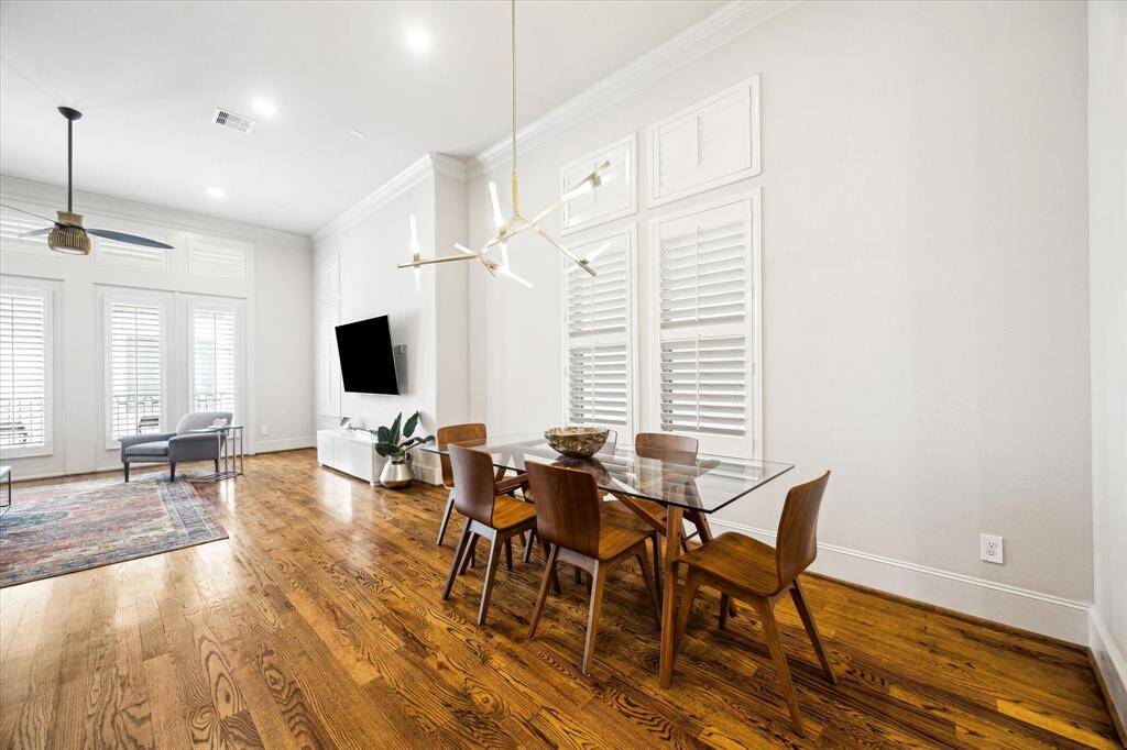 Another view of the dining area with thoughtful fixture looking towards the living room