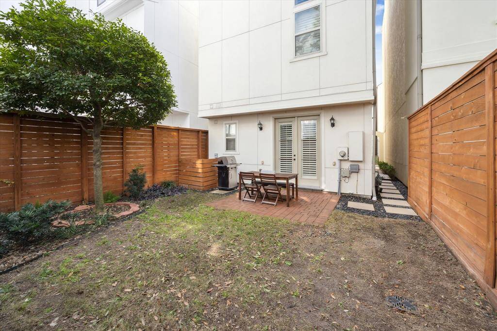 Again, there's lots of space and the black gravel with pavers make for an attractive walkway leading back to the front door. There are two access points to the yard.