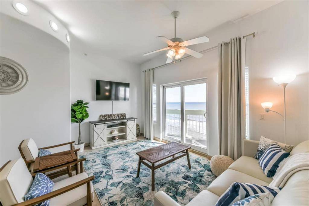 The door ahead will take you to the balcony. The sliding glass door offers amazing beach views! Take note of the overhead lighting.