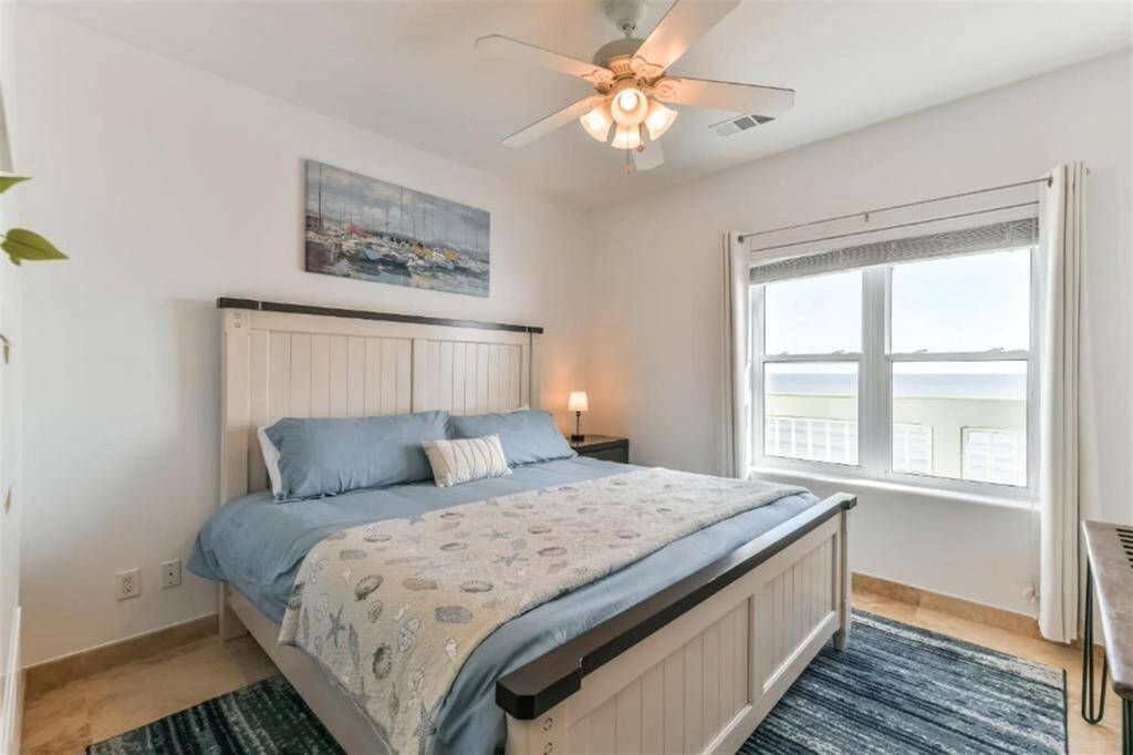 The spacious primary with king-sized memory foam bed, flat-screen TV, and breathtaking beach views!