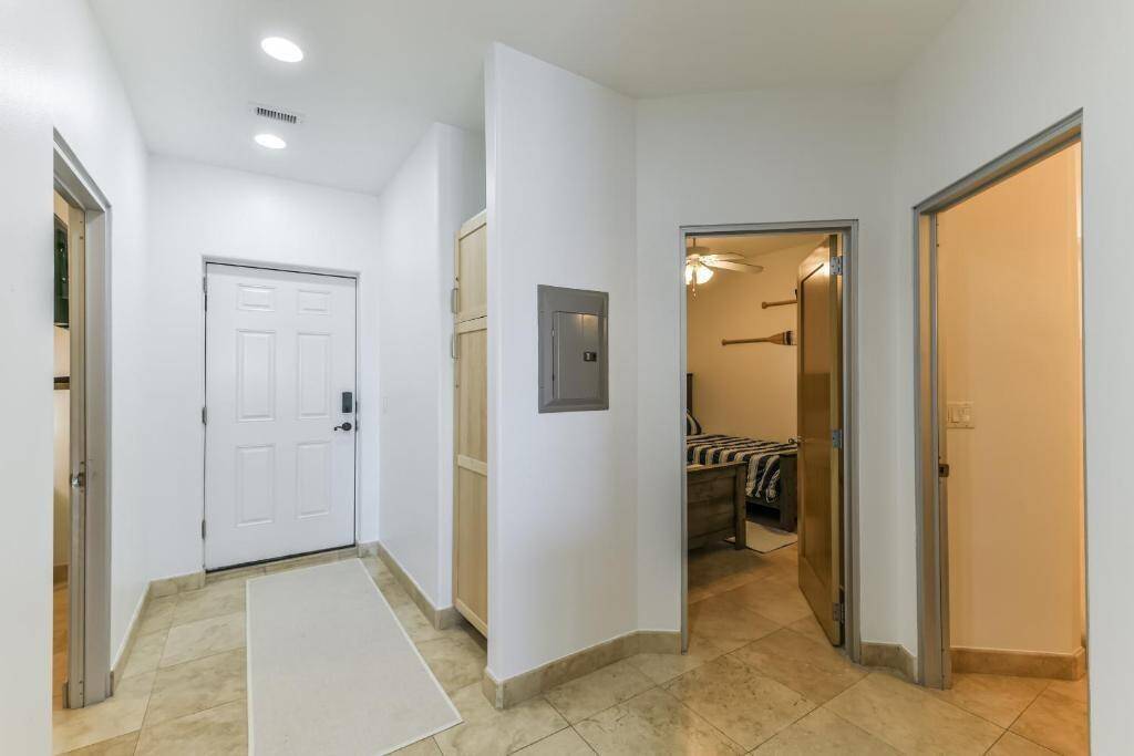 The entryway to the unit. The door to the far right us the spacious shared guest bathroom. The Middle door is the first of two guest bedrooms and the door to the left is the other guest bedroom this unit has to offer....