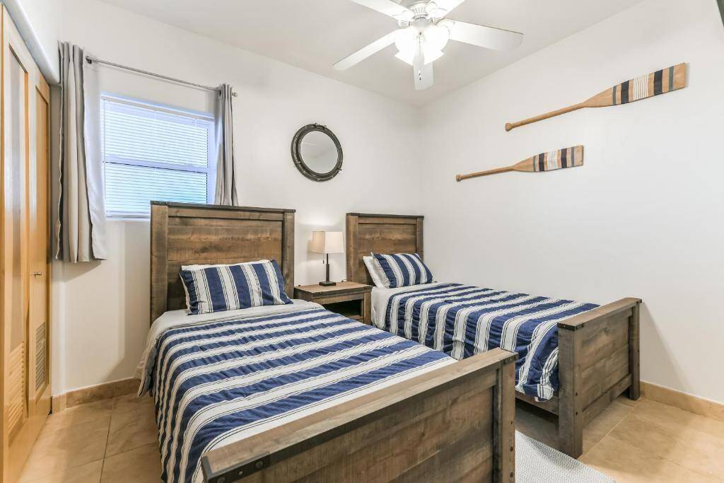 The first guest bedroom offers two twin sized beds, Tv, and large closet to the left.