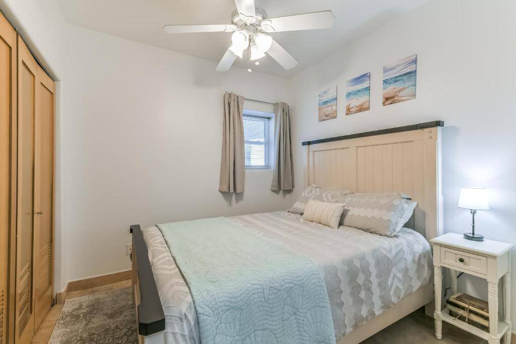 The second guest bedroom off of the entryway offers a queen-sized bed and flat-screen TV!