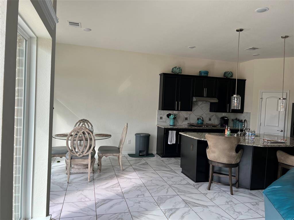Looking in living area and kitchen from short hall entry to the Primary Bedroom.