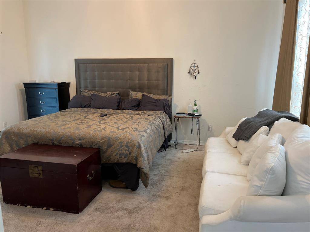Primary Bedroom, with a sitting area.  Located in the back area of the home.