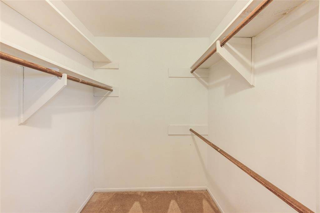 Walk-in closet in primary bedroom.