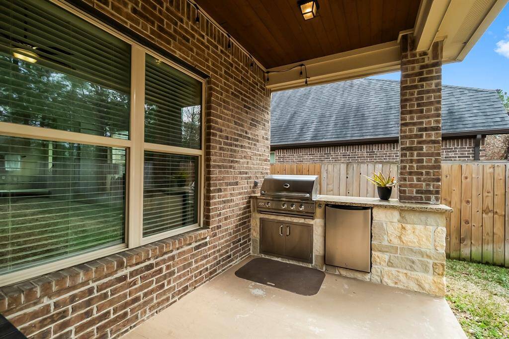 Beautiful stained shiplap ceiling over the extended patio and outdoor Kitchen is great for entertaining!