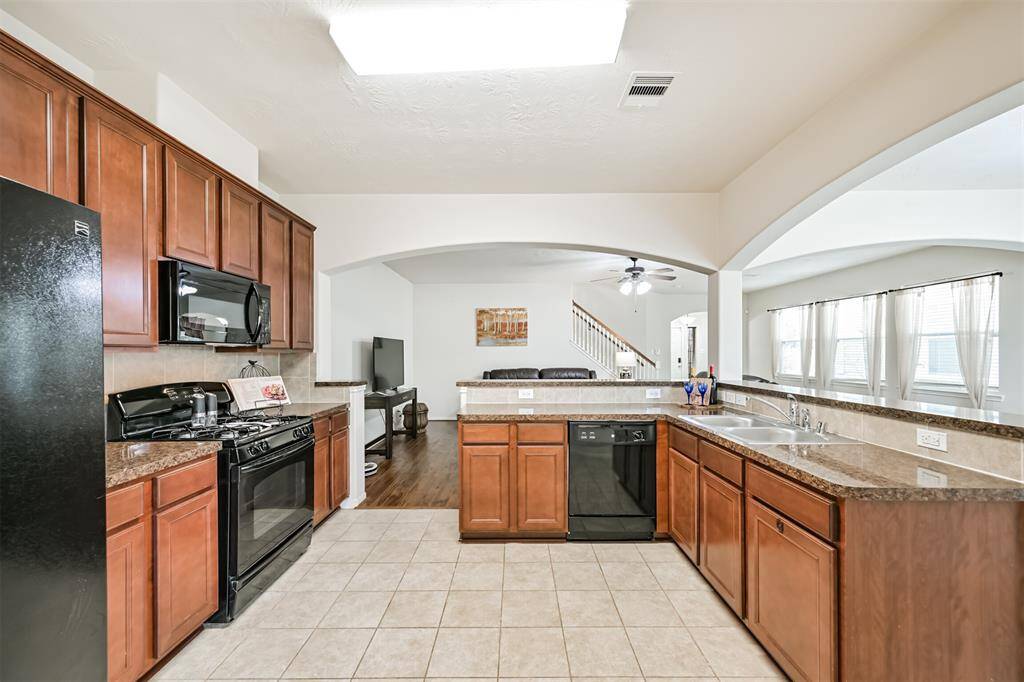 Spacious kitchen with open view to living and dining areas, perfect for entertaining!!  Features ample counter space, lots of cabinet space and a functional layout for effortless cooking and gathering.