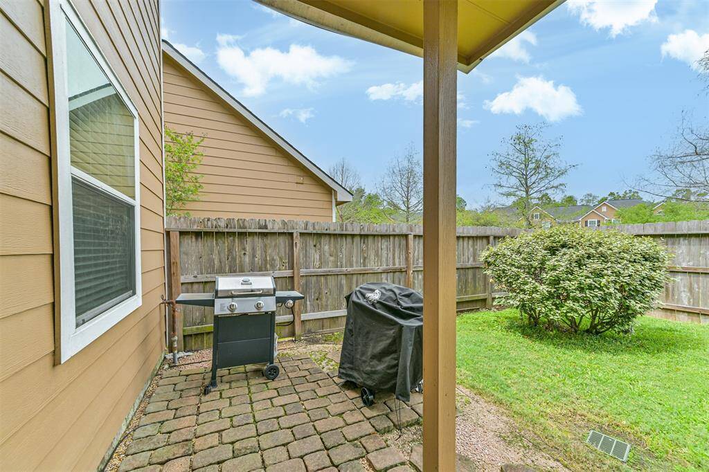 Backyard with patio and covered awning.