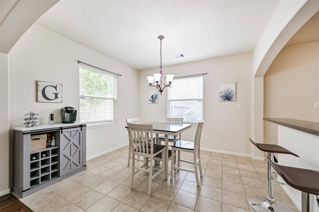 Dining area featuring large windows that fill the space with natural light, creating a warm and welcoming atmosphere.  Perfect for enjoying meals with a view!!!