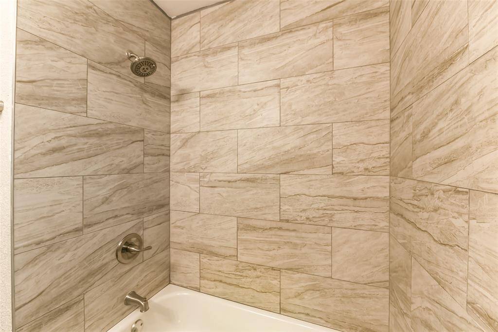 Bath has tub/tile shower surround