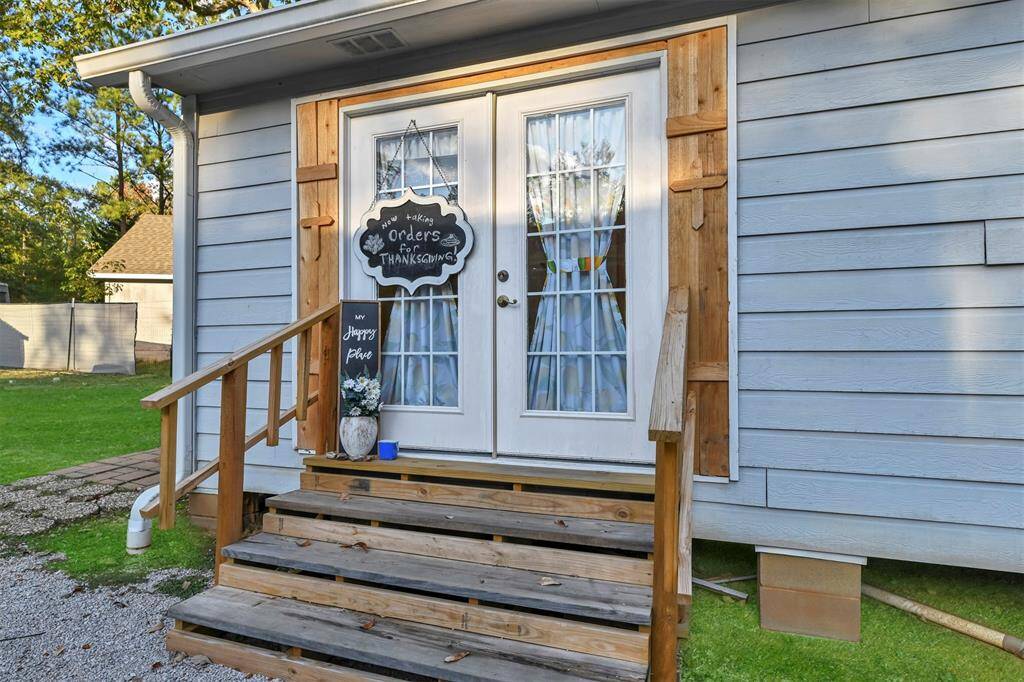 Charming front porch with vibrant accents, perfect for relaxing and enjoying the garden views.