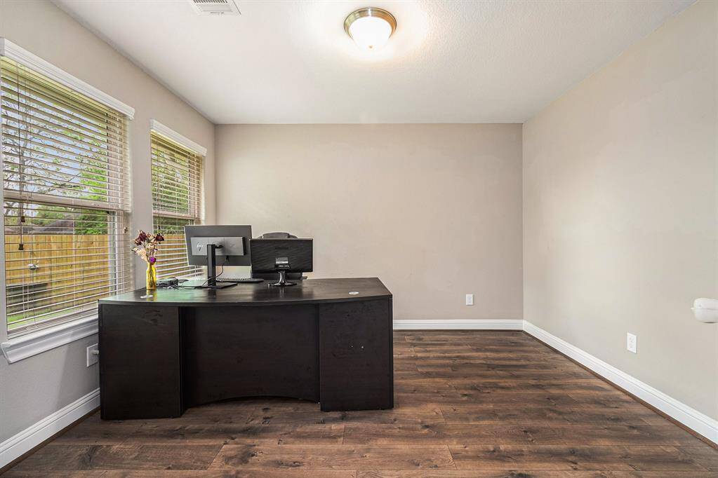 This flexible room is the perfect office space with large windows for natural lighting.