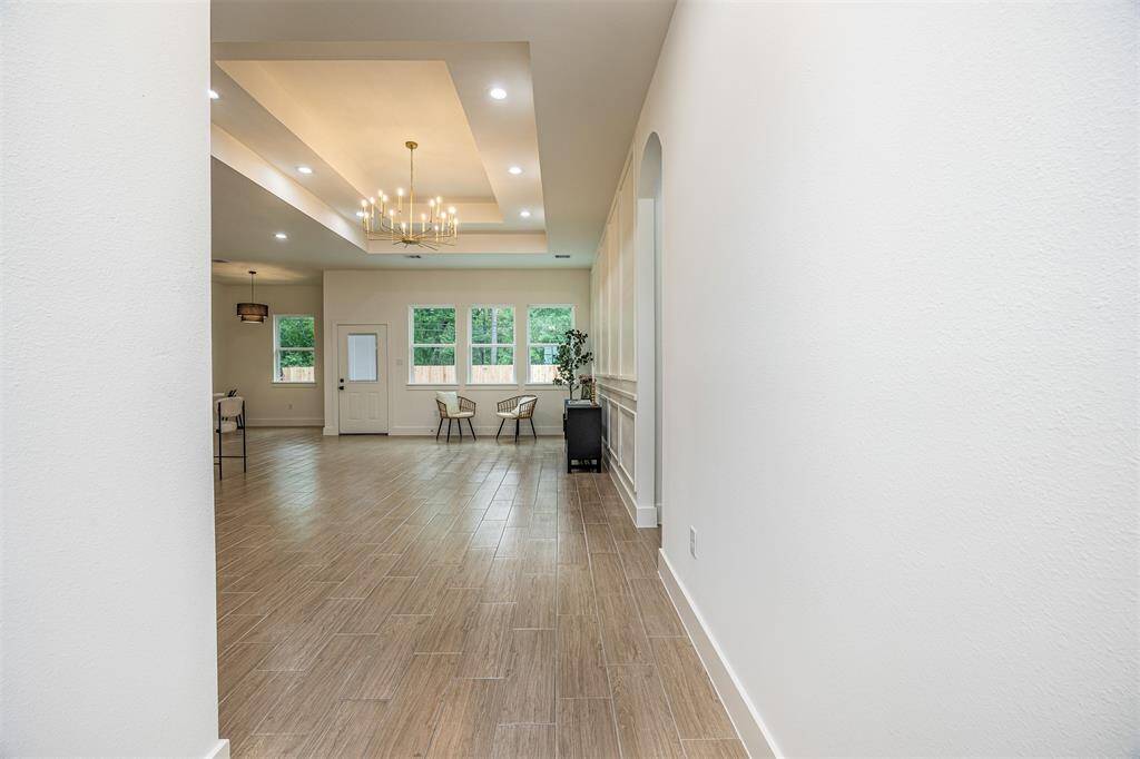As you step through the front door, you’re greeted by soaring ceilings and natural light that floods the open living space.