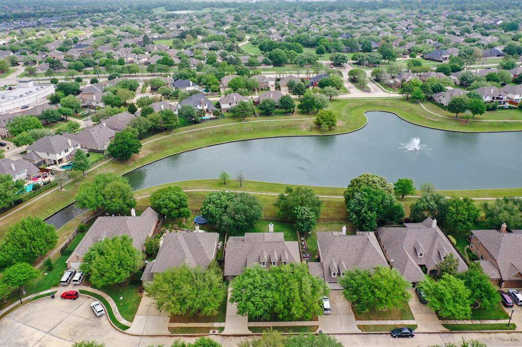 Waterfront home backs to the lake with a walking path accessed through personal iron gate!